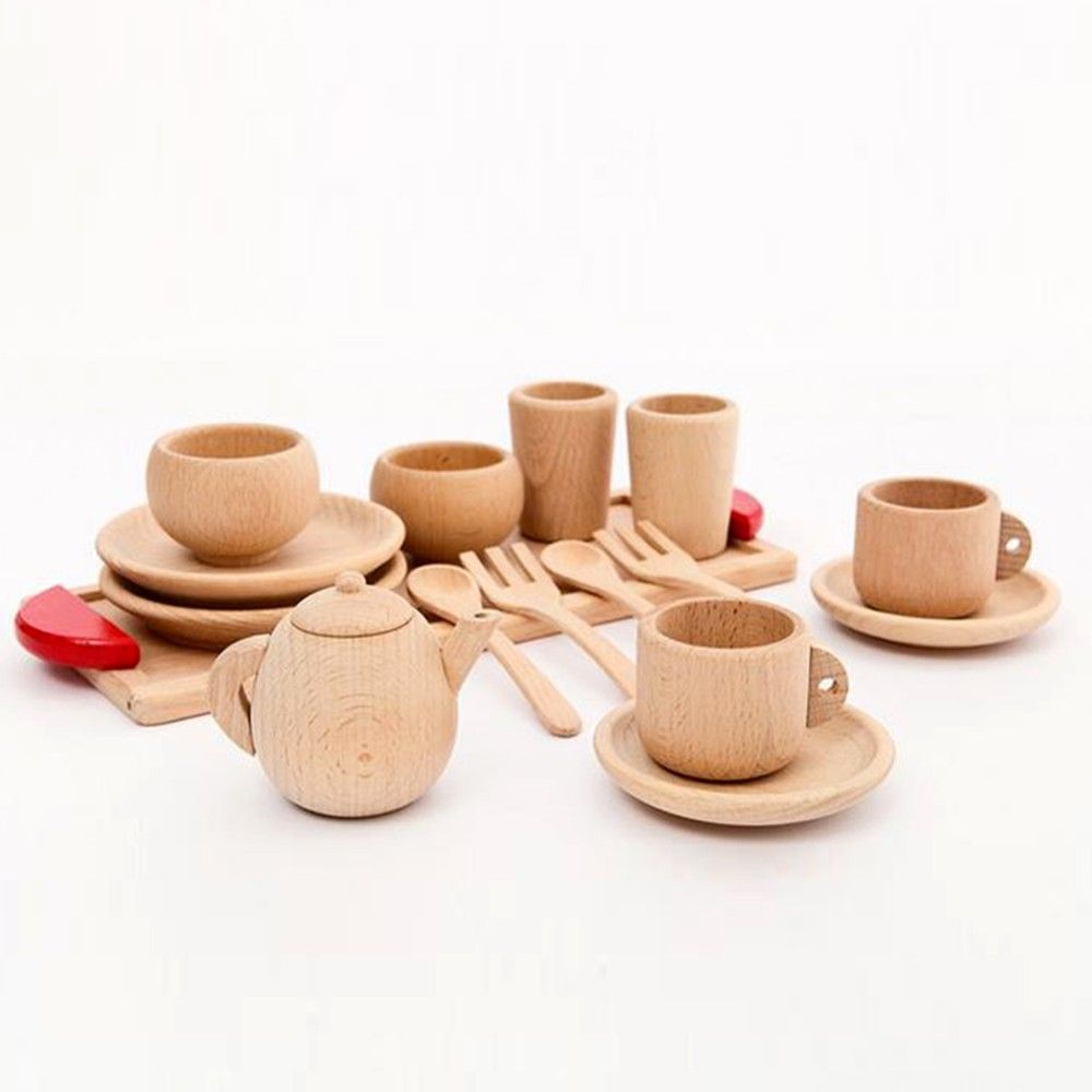 Set of wooden kitchen utensils including cups, saucers, a teapot, and cutlery on a white background