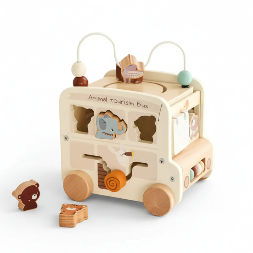 Wooden toy bus with animal shapes on a wooden surface