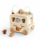 Wooden toy bus with animal shapes on a wooden surface