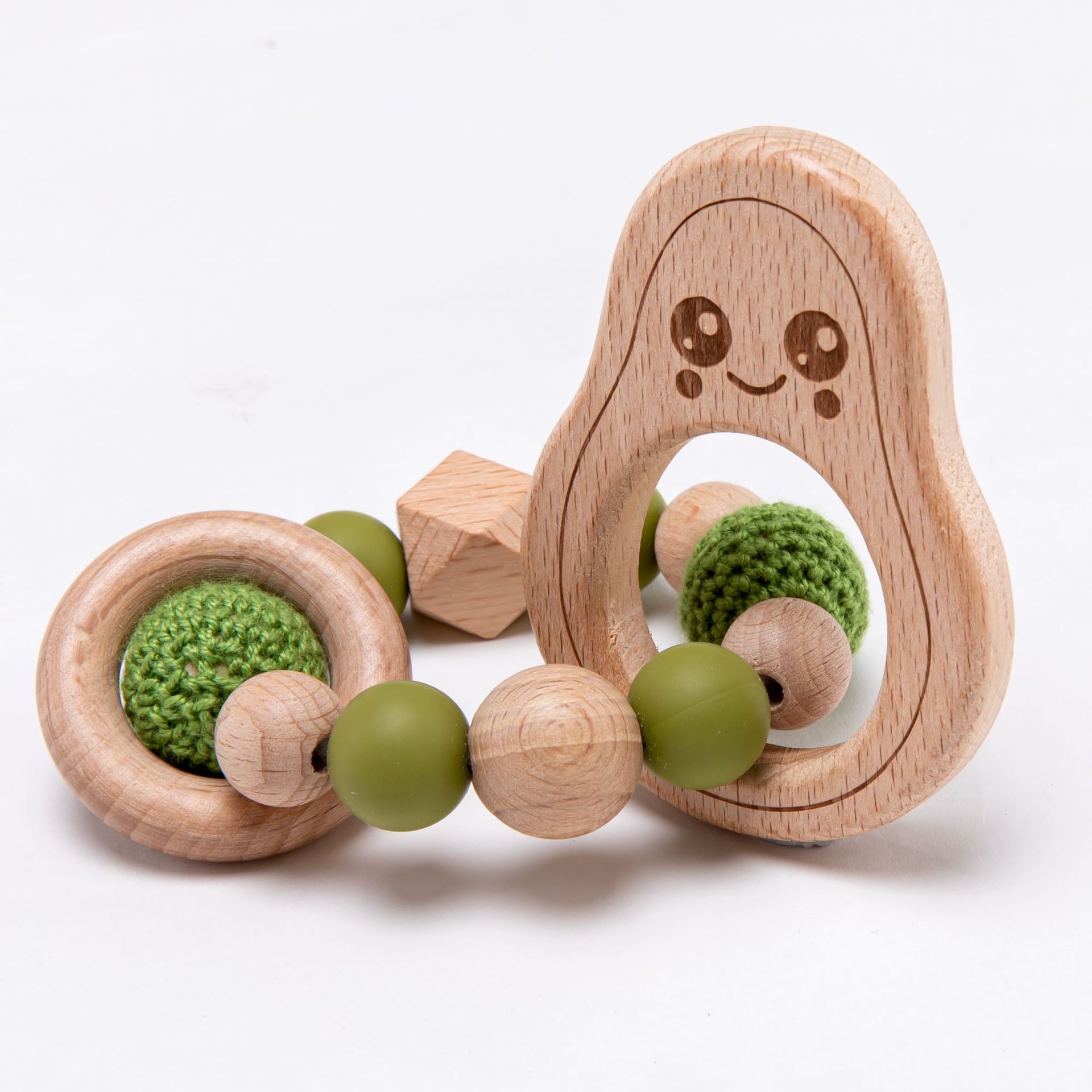 Wooden teething ring with green textured beads on a white background