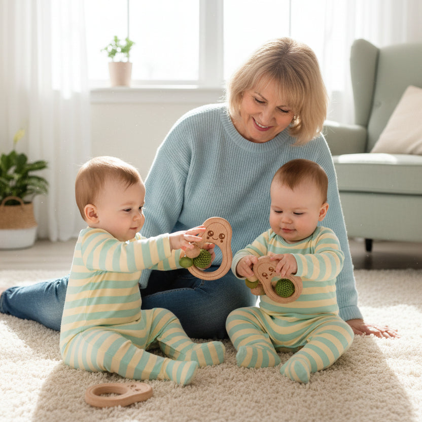 Wooden teething ring with green beads on a white background