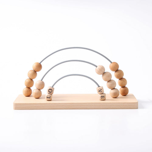 Wooden toy with beads and letters spelling 'LOVE' on a white background