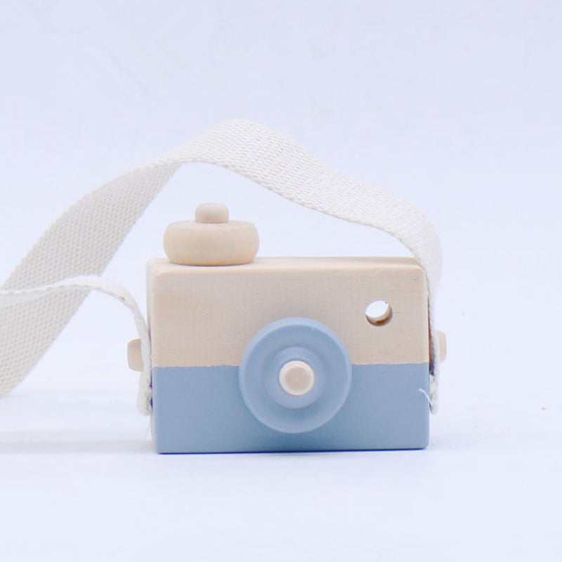 Toy camera with a strap on a light blue background