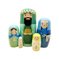 Set of nesting dolls with characters from a nativity scene on a white background.Handmade Nested Doll Navitad Set
