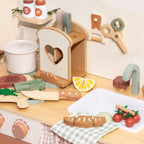 Wooden kitchen play set with various props on a table.