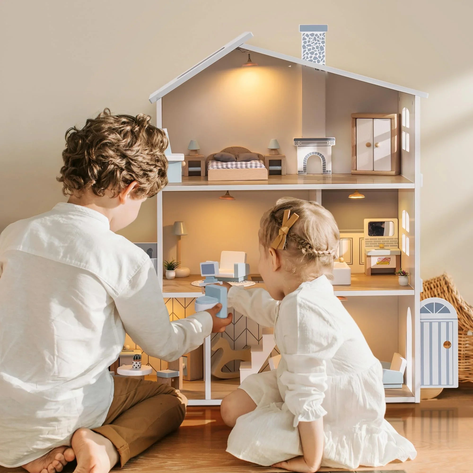 Two children playing with a detailed dollhouse.