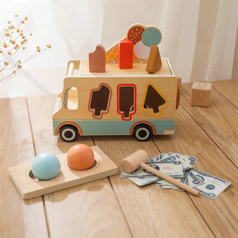 A Montessori Ice Cream Store toy made of wood, featuring a cart with different ice cream flavors, a scoop, an egg, and a bill on the side.