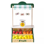 Toy fruit stand with a green roof, striped awning, and shelves displaying fruits.